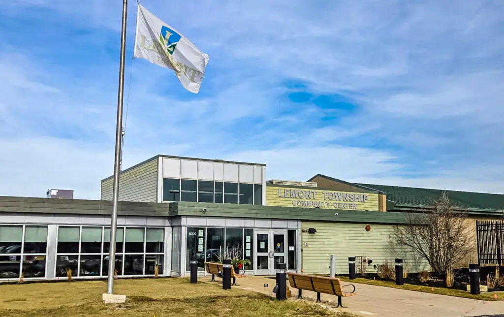 Lemont Township Community Center with flag and benches