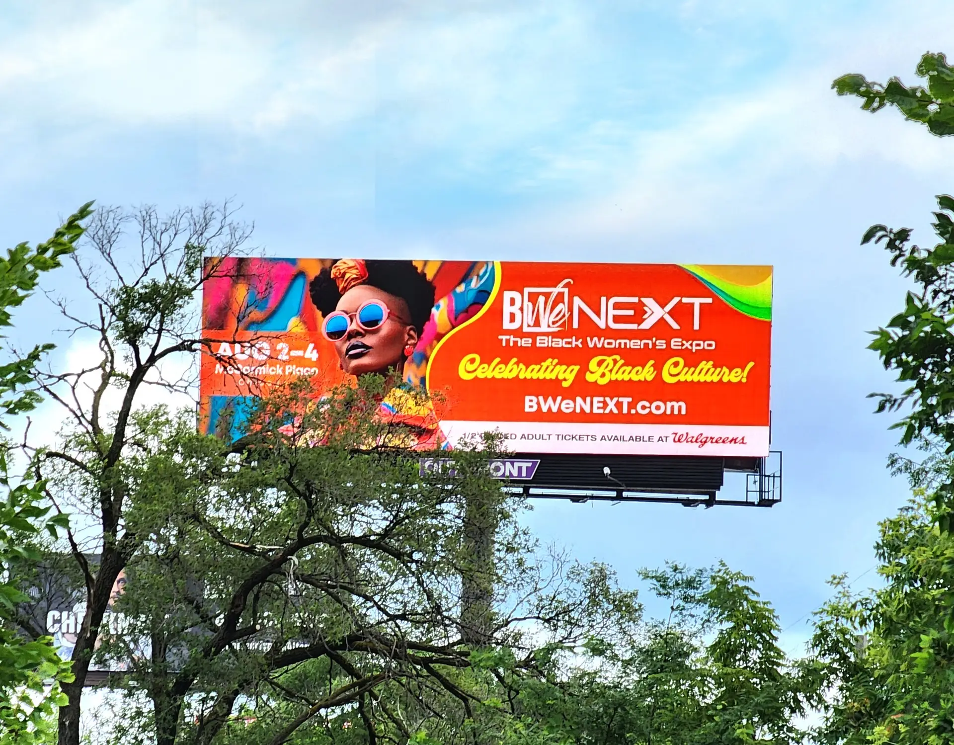 Billboard promoting BWeNEXT Black Women's Expo with vibrant colors