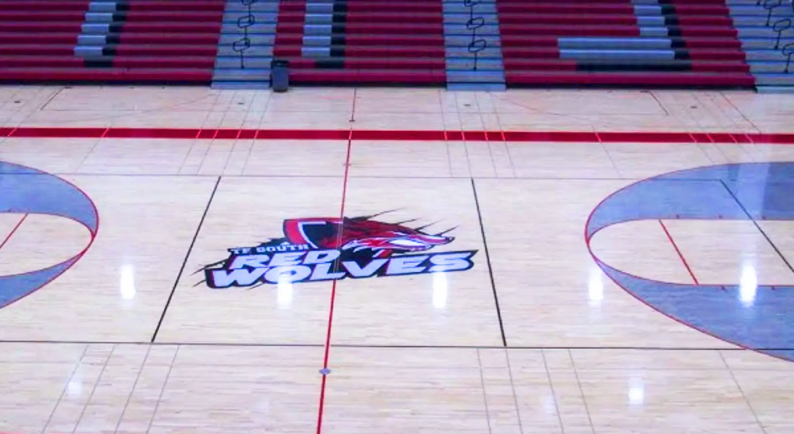 TF South Red Wolves basketball court with team logo