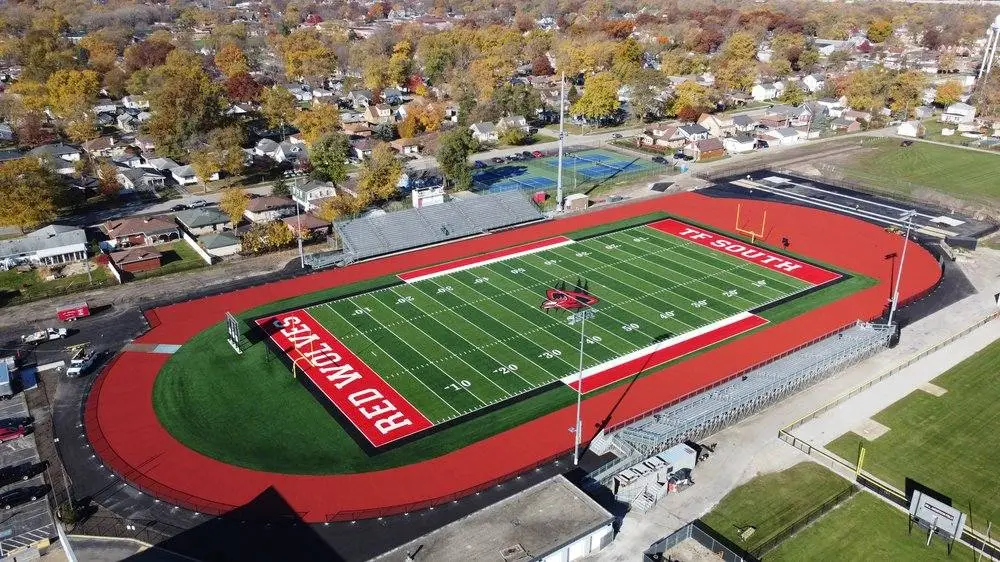 Aerial view of high school football field at TF South in a residential area